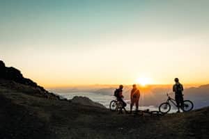 FP Events | Switzerland Tourism/Filip Zuan, Mountain bikers enjoy the sunrise on Piz Nair.